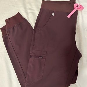 FIGS women’s Zamora jogger scrub pants in Medium. Color dark fig
